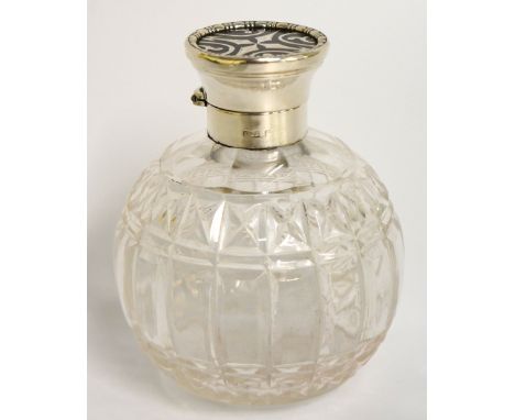 A silver and tortoiseshell topped scent bottle the hinged cover flat with circular tortoiseshell panel inlaid with silver sta