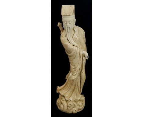 A Chinese crackle glazed figure of an immortal with blanc de chine head, beard and hand, impressed seal mark to back, 44cm hi