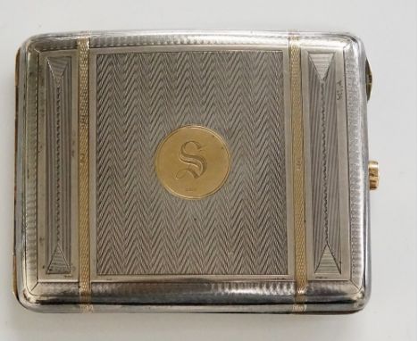 An Art Deco silver and 9ct gold cigarette case of rounded rectangular concave form with engine turned bands the front with ci