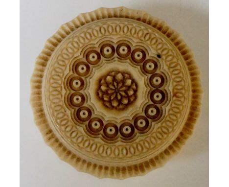 An early 19th Century ivory box, finely engine turned throughout, 6cm diameter, 3cm high, 75gms