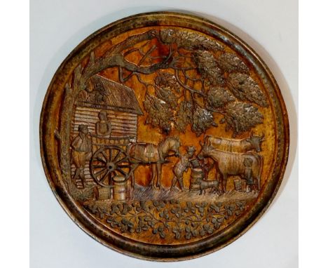 A large 19th Century Irish butter print, relief cut in reverse with cow, figures, horse and cart with leafage and shamrock, p