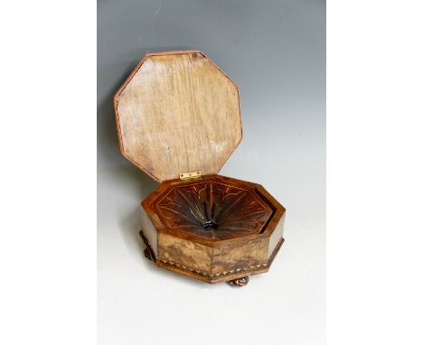 A Victorian walnut octagonal stool/spitoon the hinged lid upholstered in floral petit point revealing a ceramic spitoon, the 