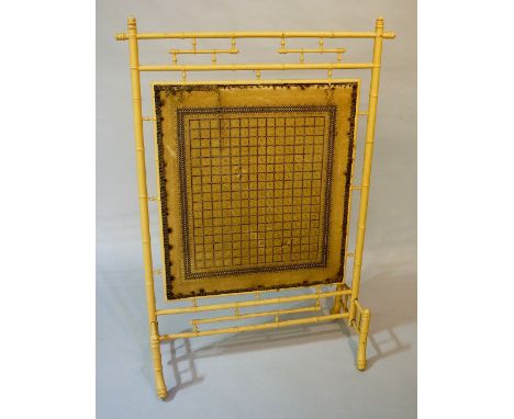 An Arts and Crafts Japanese revival fire screen with faux bamboo surround and tapestry panel, 116cm high, 82cm wide max., lat