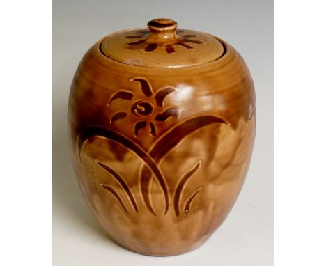 A Clevedon pottery large lidded jar and cover by William Fishley Holland, the caramel glaze with stylised flowers and leafage