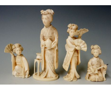 A set of four 19th Century Japanese ivory Geisha figures, one holding a teapot, another playing musical instrument, the other