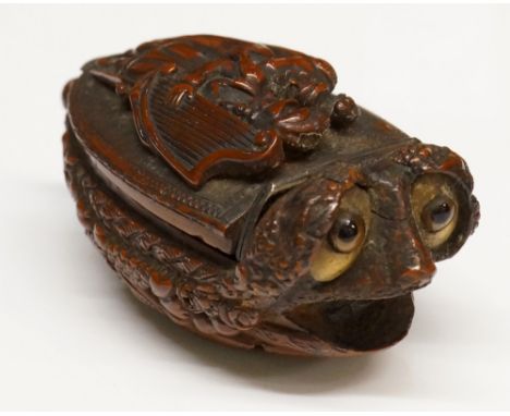 A highly unusual 19th Century carved wood vesta modelled as a stylised dog with glass and bone eyes the hinged cover finely c