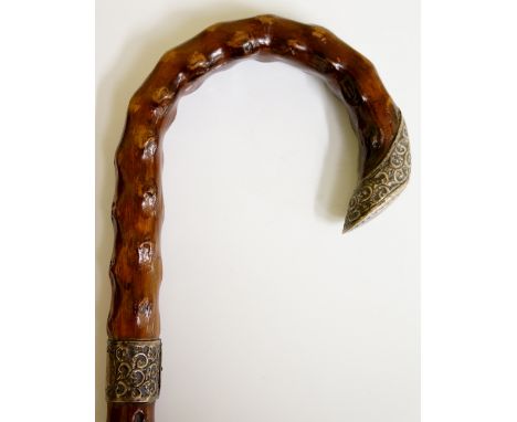 A Bentwood briar stick with foliate embossed silver terminal, the collar with vacant circular cartouche, 91cm long