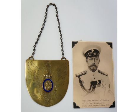 A Russian shield shaped enamelled brass plaque engraved with 'eagle' applied crown and blue enamel oval centred on Mary and C