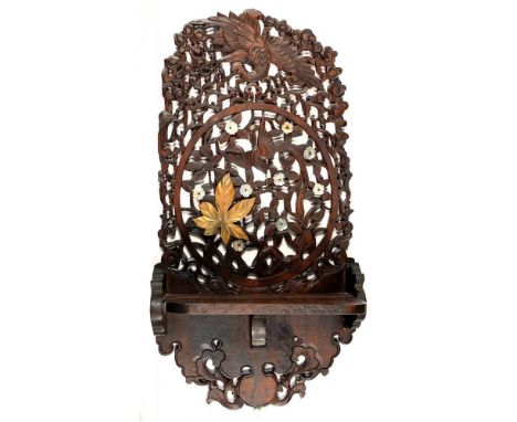 A JAPANESE CARVED AND LACQUERED WOOD BRACKET SHELF, THE PIERCED WALL PLATE WITH BIRDS AND FLOWERS WITH APPLIED MOTHER OF PEAR