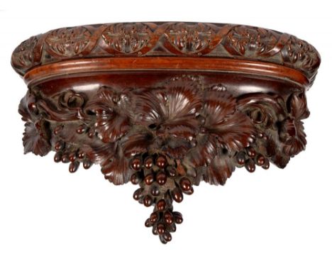 A VICTORIAN CARVED MAHOGANY BRACKET SHELF WITH GUILLOCHE AND FRUITING VINE, 40CM L