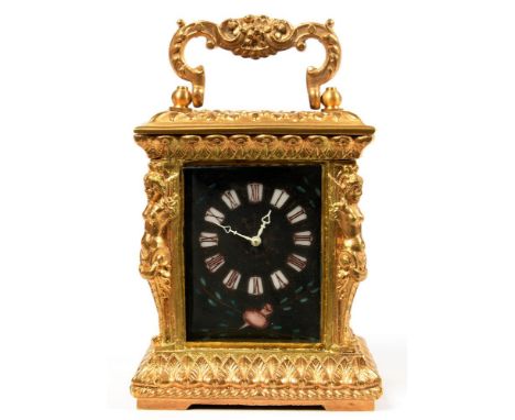 AN ORNATE GILTMETAL MINIATURE CARRIAGE TIMEPIECE WITH ENAMEL MASK DIAL, 8.5CM H EXCLUDING HANDLE, 20TH C