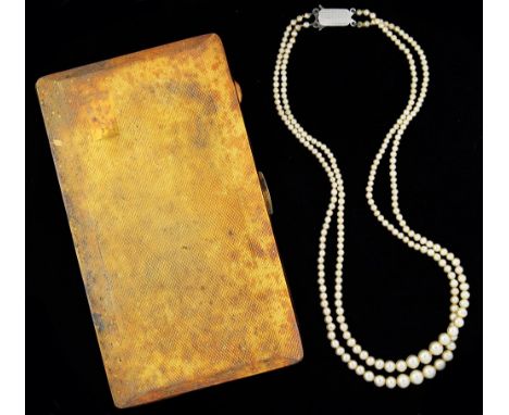 A GOLD PLATED ARISTOCRAT CIGARETTE CASE AND A DOUBLE STRING OF IMITATION PEARLS, WITH ENGINE TURNED SILVER CLASP ++TARNISH AN