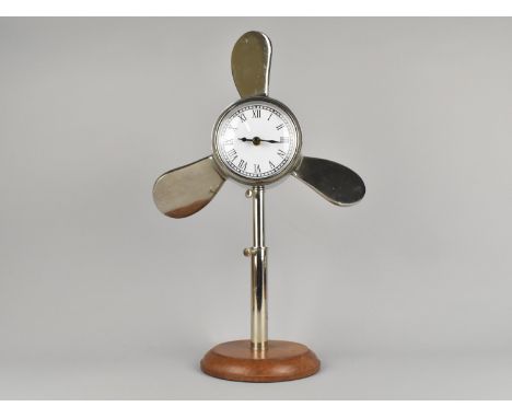 A Modern Rise and Fall Novelty Mantel Clock in the The Form of a Ships Propellor, Circular Wooden Base