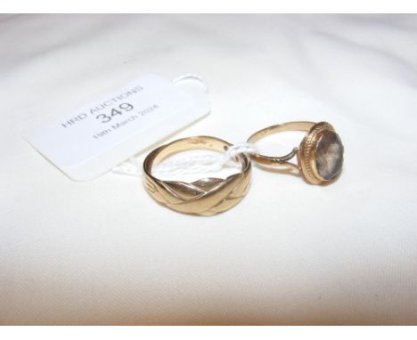 A gold dress ring and one other