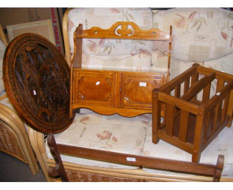 A wooden magazine rack, carved wooden wall plaque and a wall shelf and cupboard unit 