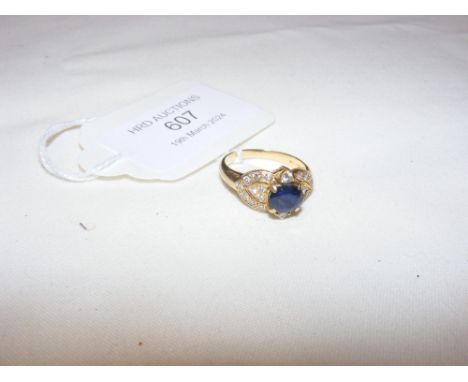 A sapphire and diamond ring in 18ct setting CONDITION REPORT Sapphire is 5mm x 6mmGross weight 4.4gApproximate band size, MWe