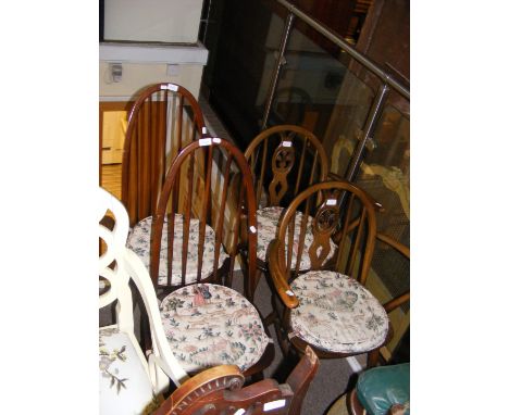 Two Ercol stick back chairs together with two similar armchairs