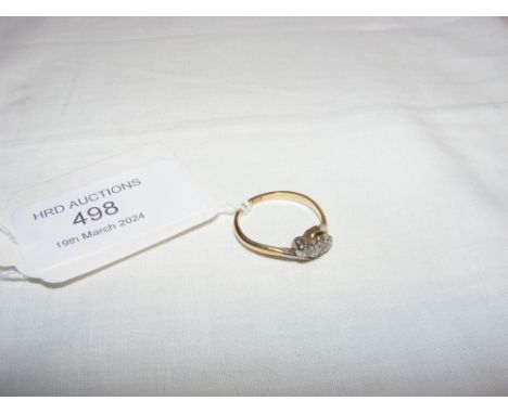 A three stone diamond ring in gold setting