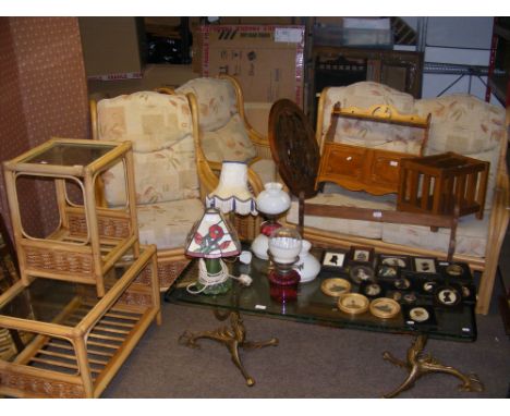 A bamboo and cane framed conservatory suite, consisting of two seater sofa, two armchairs and two glass top coffee tables 