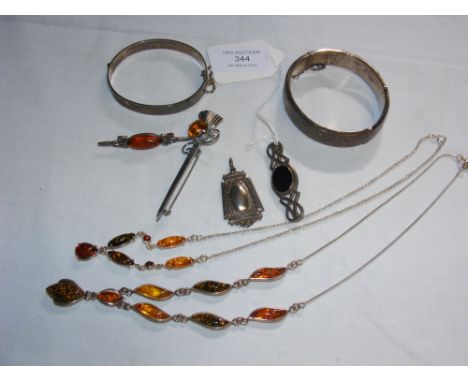 A silver bangle, brooches etc.