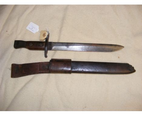 A bayonet in leather scabbard - overall length of bayonet 37cm 