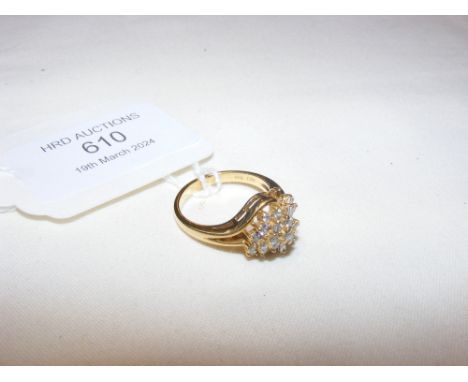 An 18ct ring with diamond mounted swirl design