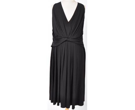 From the collection of Angela Grant - Tahari - a ladies evening black dress, with V-neck and pleated skirt, with a sash to th