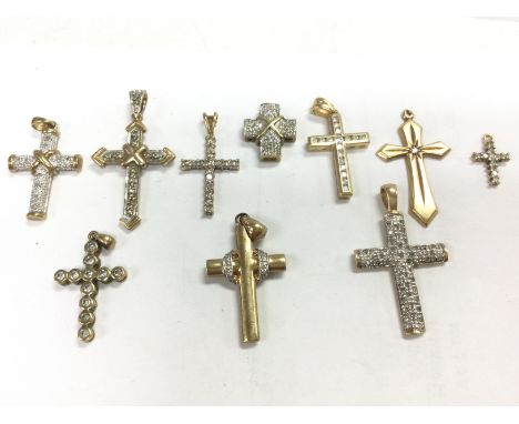 A collection of 9ct gold cross pendants , some set with diamond stones. Total weight 14.9g Postage category A