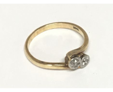 An 18carat gold ring a two diamond crossover illusion set with platinum. Weight 3.5g
