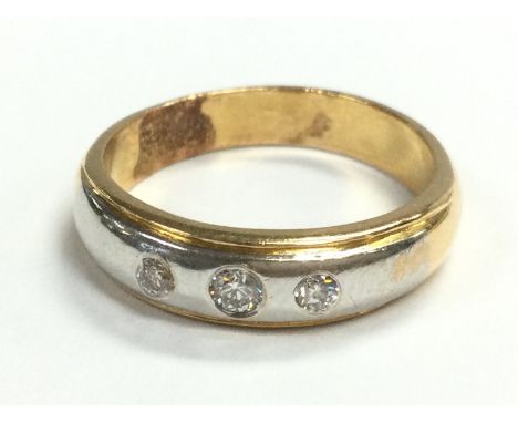 A 18ct yellow and white gold three stone diamond band ring , size M, 5.5g. Postage category A