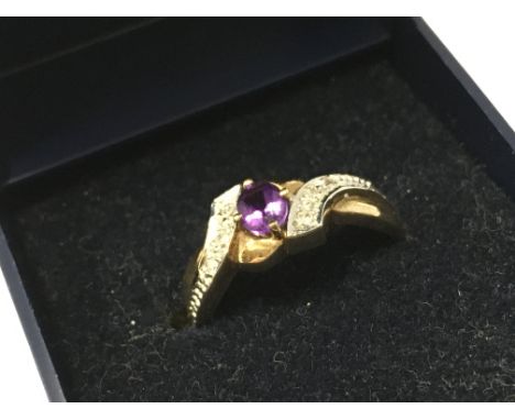 A purple sapphire and diamond set 9ct gold ring , size O. 3g total weight