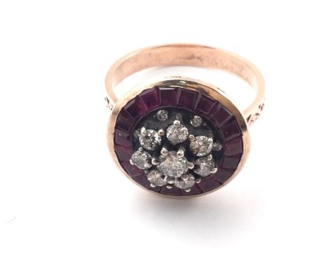 Unhallmarked rose gold target style ring set with diamonds and calibre cut rubies with patterned shoulders. Approx 0.85ct and