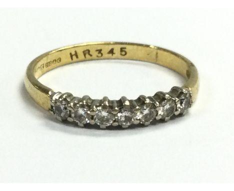 An 18ct gold seven stone diamond 1/2 hoop ring . 1.9g. Size L/M Postage category A