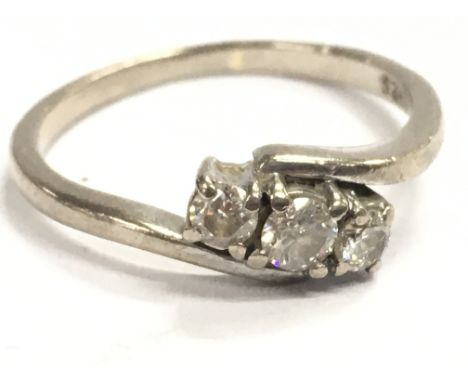 An 18ct white gold three stone diamond ring , size M. 2.6g Postage category A