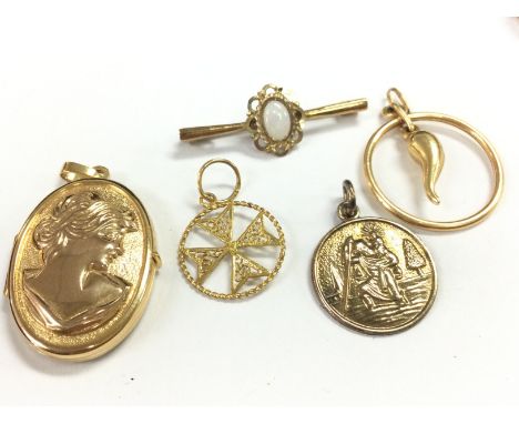 A collection of 9ct gold pendants Including horn of life, St Christopher, a small opal brooch , locket, Maltese Cross. 9.3g t