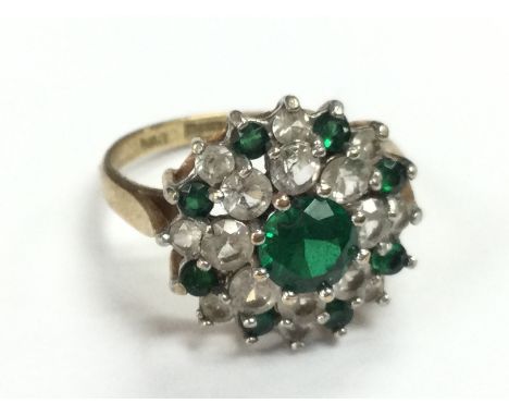 A 9ct gold ring set with green stones and simulated diamonds , size M. 3g total weight. Postage category A