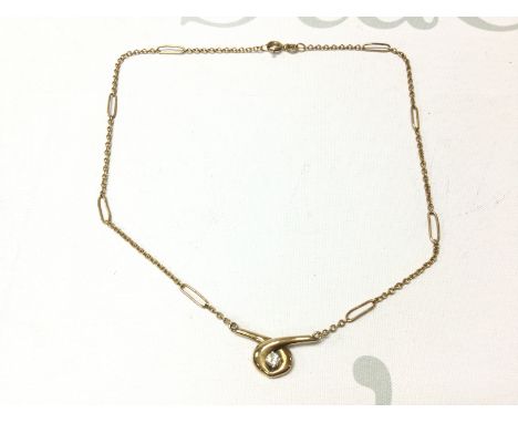 A 9ct gold necklace set with a single moissonite. 6.24g Postage A