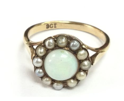 A 9ct gold opal and seed pearl set ring, total weight 3.4g . Size Q. Postage category A