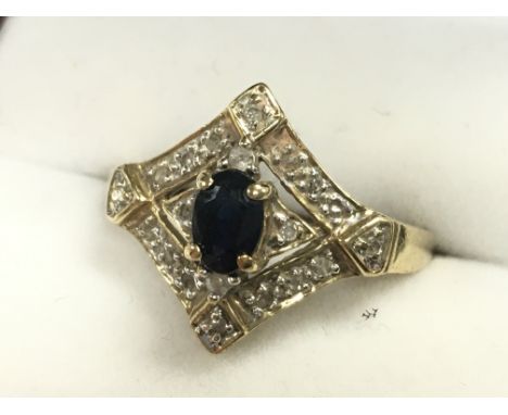 An art deco 9ct gold diamond and sapphire set ring, size R. 2.7g total weight. Postage category A