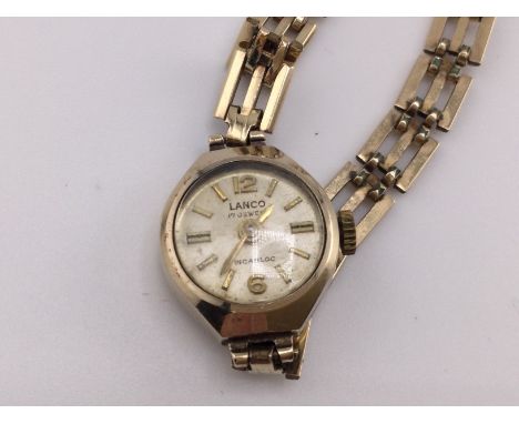 9ct gold vintage gold ladies watch with 9ct metal core strap. 9.95g