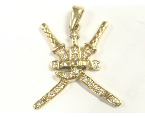 An 18ct gold diamond set katanas and dagger pendant , 3.7g total weight. Postage category A