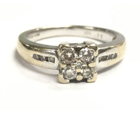 An 18ct white gold diamond cluster ring, size K/L. 4.5g total weight. Postage category A