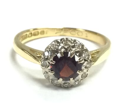 An 18ct gold garnet and diamond cluster ring , size K. 3.3G Postage category A