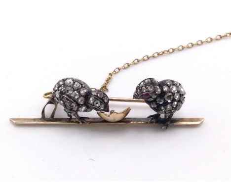 A unmarked gold brooch set with diamonds and rubies birds. 7g .
