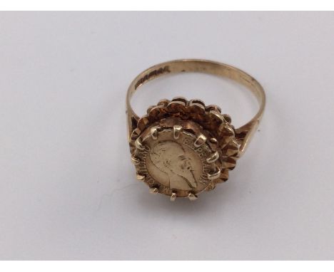 A 9ct gold ring set with an 1865 Maximiliano coin. Size P and 3.49g