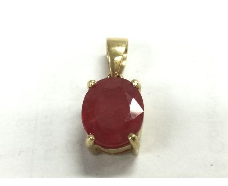 An 18ct gold ruby pendant , 2.6g. Postage category A
