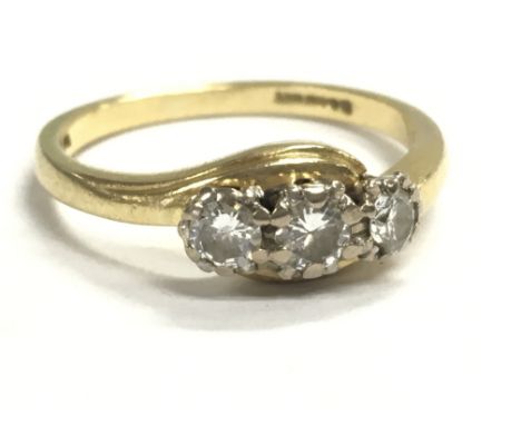 An 18ct gold three stone diamond ring, size N/O. 4g total weight. Postage category A