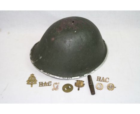 A British Post WW2 1953 Dated MKIV "Turtle" Helmet With A Small Selection Of Military Badges And Tool Kit.