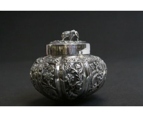 White metal tea caddy of gourd form, repousse jungle scene decoration depicting lions, elephants, gazelle etc, floral and fol