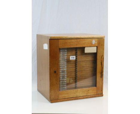 Vintage Wooden collectors specimen Cabinet with Lockable glazed front and 28 drawers containing numerous vintage glass Slides